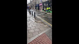 Burst water main cracks open road in North London