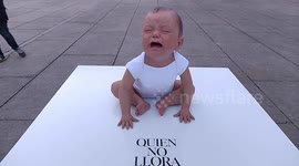 Realistic giant baby set up in Madrid crying for laws to protect public breastfeeding