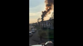 Flat on fire. Black smoke coming out of the building and over 60 fire fighters came rushing along with police cars.