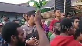 A number of residents in a city in Indonesia, burn a middle-aged woman in front of her daughter