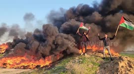 Palestinians burn tires during a protest against the killing of 9 Palestinians during an Israeli raid in Jenin near the fence with Israel east of Gaza city