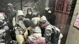 Dedicated Chinese tourists wait on freezing mountain top just to see the sun rise