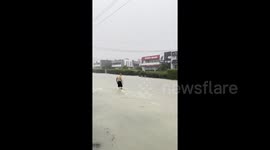 New Zealand man skips gym and exercises in the middle of the street as floods turn roads into rivers