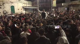 Palestinians chant as they celebrate in the center of Nablus city in the West Bank
