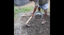 The Indian laborer is taking sand mixed with cement stone .The Mixing Ratio of Cement And Sand to Build a House Wall
