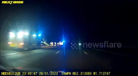 Fire Service vehicles rush to attend to upturned vehicle in trees at side of M40 near Finwood, Warwickshre on dashcam