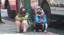 Residents wear sweaters and ear-muffs as temperatures fall below 20C in Bangkok