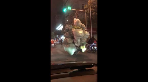 Moterbike incredibly overloaded with a mountain of cargo