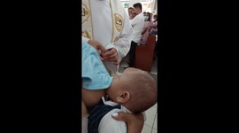 During Christening of the baby in Church where the Priest was shock because the baby was breastfeeding while the ceremony was ongoing