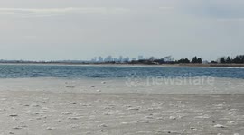 Boston City Skyline and Freezing Salt Water from Red Rock Park in Lynn, Massachusetts