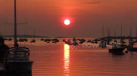 Sunrise With Passing Lobster Boat With Stern Man Throwing Trap Overboard