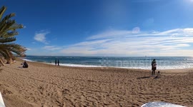 Barcelona, Spain timelapse of the beach on a sunny day with people swimming and sunbathing. 4k stock footage