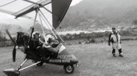 Hang glider flight in Nepal, stylized as an old movie