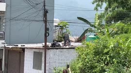 Two guys fighting on roof of building in Nepal