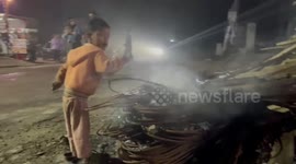 Homeless child in Winter heating up over fire on the road in Nepal