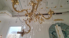 Palestinians inspect a damaged wedding Photography studio following Israeli strikes