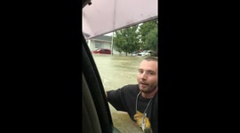 Evacuating car through chest-high waters during Auckland, New Zealand flood