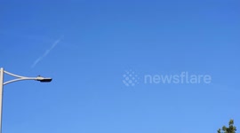 A strange UFO was seen over Hainult in East London. the what appears to be a spherical object appears to appear and disappear in the same spot