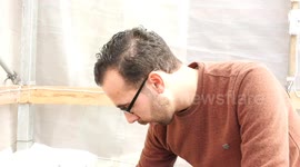 Palestinian, Abdul Qadir Bakr, 28, inspects his greenhouse where algae are grown