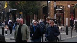 Crowd of people walking through Seven Oaks in front in the Diesel Store, London, United Kingdom