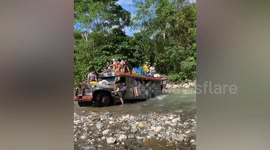 Overloaded bus struggles to cross river in the Philippines