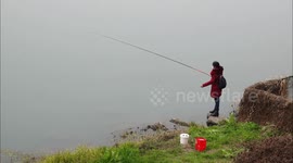 Fishing Enthusiasts Fish By the Huangbai River in Yichang, China