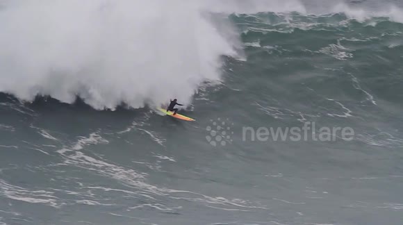 Surfers ride huge Christmas waves in Portugal