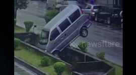 Minibus plummets into ditch after being hit by turning car in China