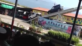Two 4x4 cars perform balance stunt on huge seesaw