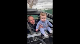 Manchester United manager Erik ten Hag holds baby out of car window during fan meeting