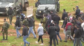 Palestinian protesters run from tear gas canisters fired by Israeli forces