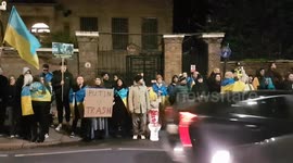 Pro-Ukrainian supporter leaves a toilet outside Russian Embassy as British-Ukrainians gather to mark one-year anniversary of the war