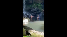Careless visitors bathe in protected Curtis Falls, Australia, ignoring clearly laid out signs