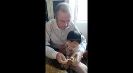 An adorable toddler is sampling boiled egg for the first time.