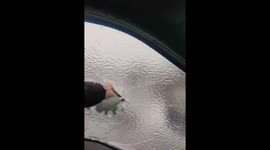 Viral video shows NY police officer punching through a sheet of ice covering car window
