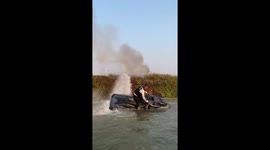 Chinese man uses motorboat to splash water from river to extinguish fire