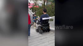 Electric wheelchair negotiates steep set of steps in Hong Kong