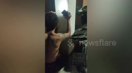 Kitten stuck in concrete pillar saved by resident breaking it open with mattock