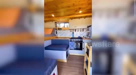 Man who converted old ambulance into self-sustainable camper now saves more $15k a year on rent and bills