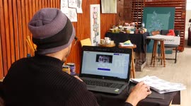 Palestinian artist, Muhammad Qureiqa, draws with the technology of linking the barcode to the Rubik game box to convert images into encrypted data within the 