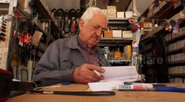 Palestinian men, Khalil Da'oud 76, and his son Ahmed, 38, display the vintage Fiat car at their shop in Gaza city