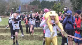 UK Wife Carrying Race in Surrey has couples dodging hay bales and water hazards on 380m course