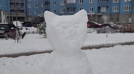 Children create snowmen in the local court yard of St Petersburg,  Russia