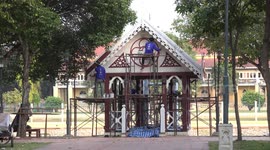 Painters at work at the grounds of a beautiful Buddhist temple, at Ayutthaya, Thailand.