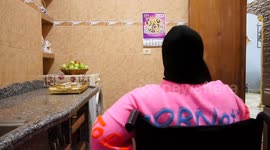 Palestinian woman of special needs, Nour Ershi, 29, sits with her family on the occasion of International Women's Day, at her home
