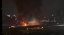 Fire rips through warehouse next to JFK Freeway in Omaha
