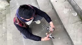 Passersby attempt to separate birds engaging in epic battle on pavement