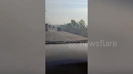 Long hose rattles behind moving pickup truck in Thailand