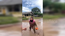 Wading in Mud: Indonesian Residents Protest Unrepaired Potholed Roads with a Unique Tactic