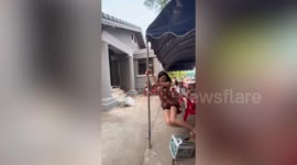Acrobatic woman amuses wedding guests by spinning like pole dancer